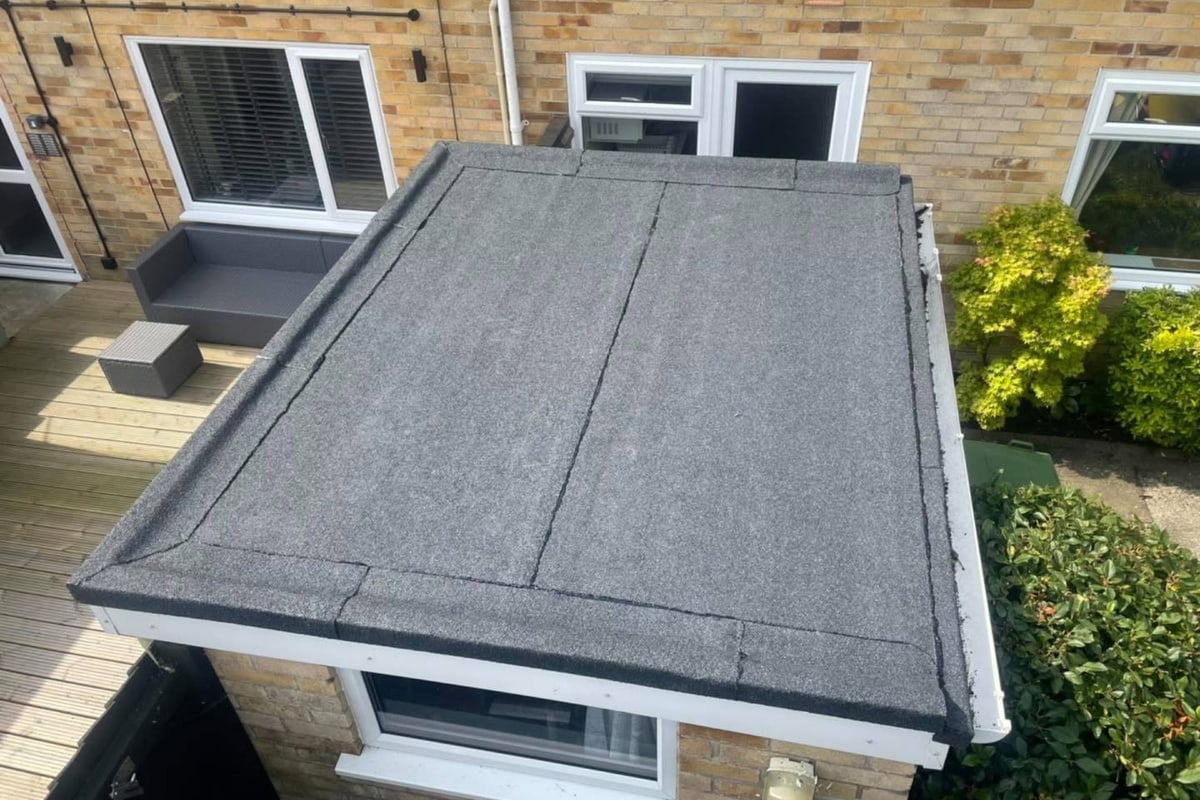 A torch-on felt flat roof over an extension