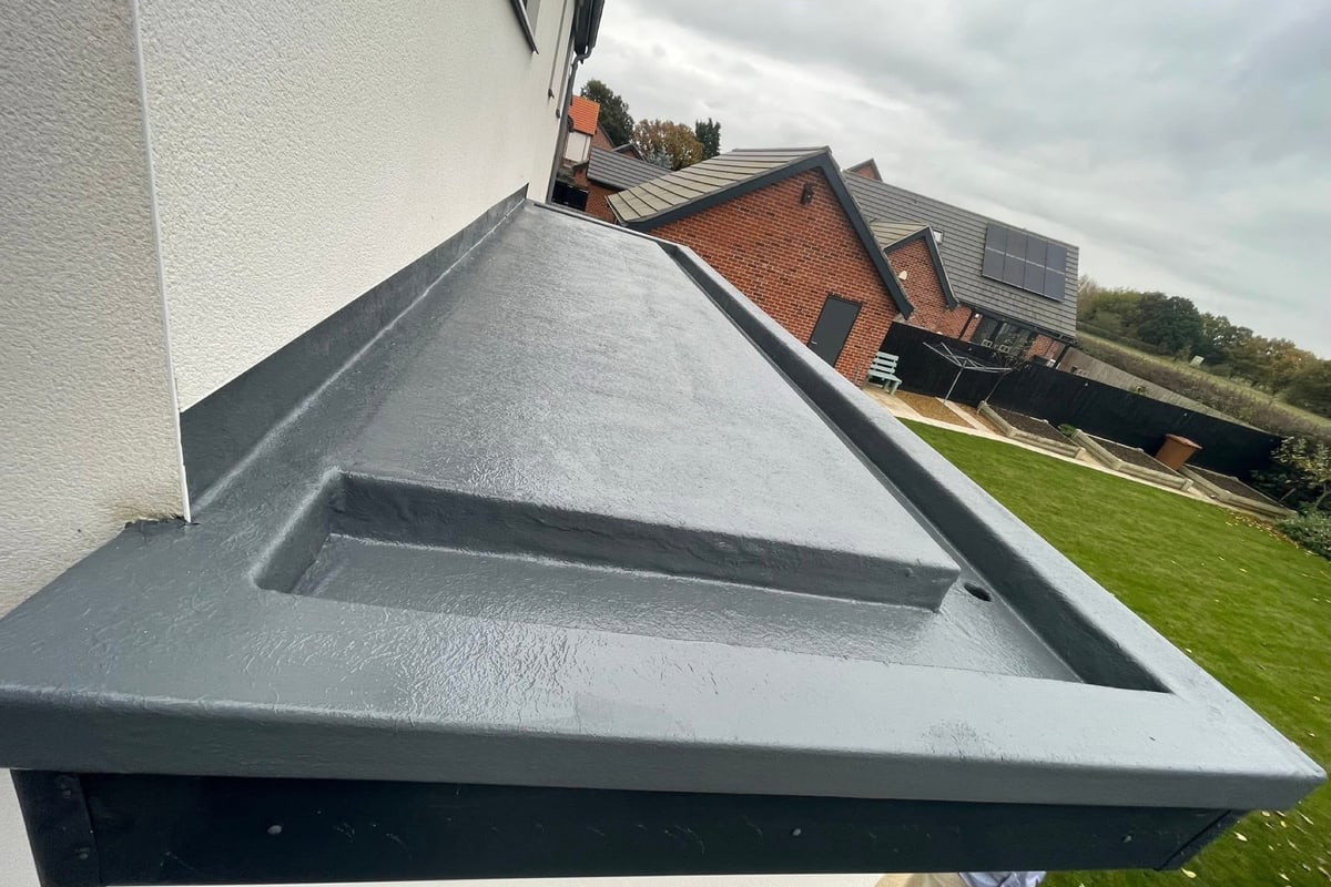 A grey GRP fibreglass roof over a bay