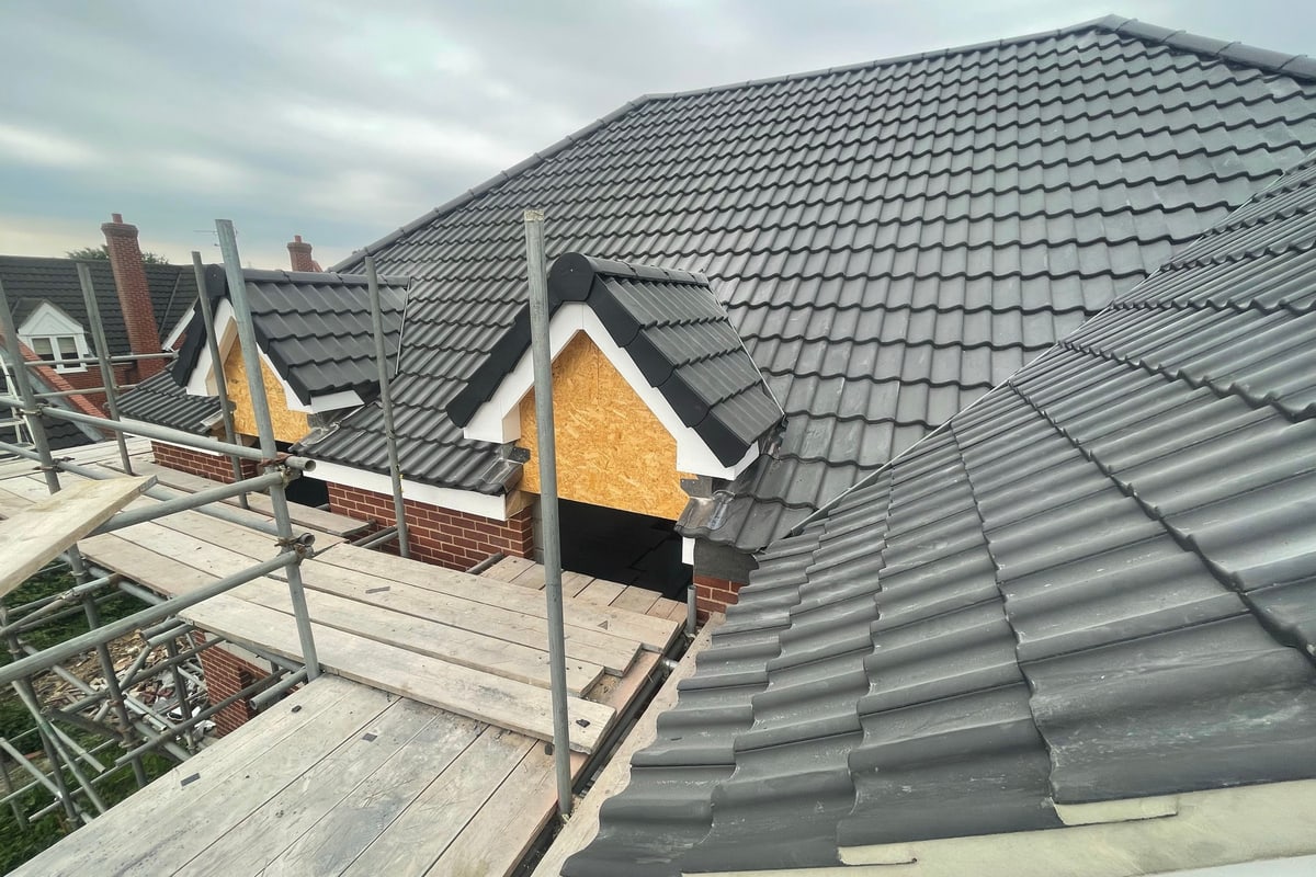 Grey interlocking concrete tile roof by District Roofing