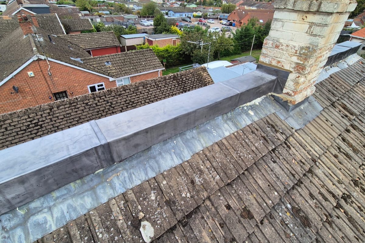 New leadwork along a roof ridge and chimney