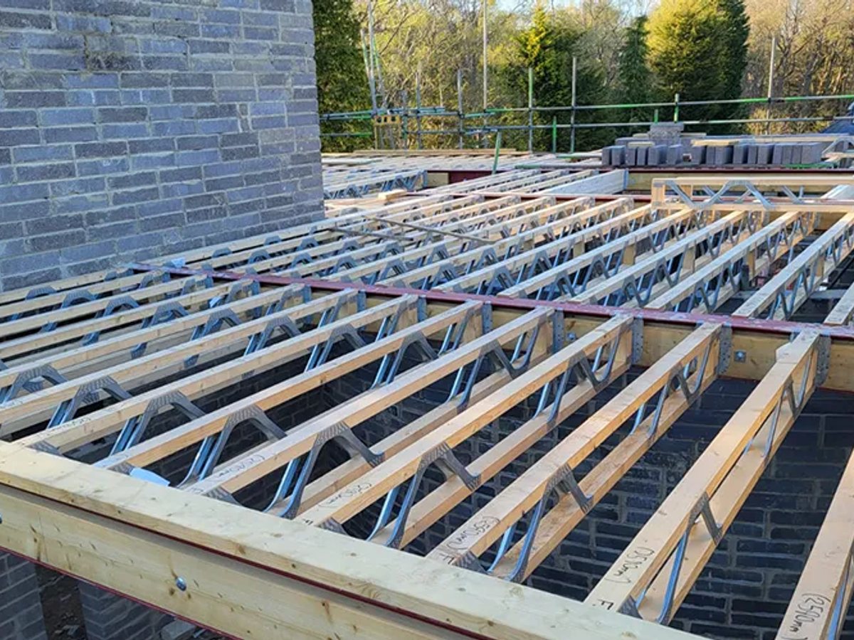 Metal web joists across a new floor, ready for decking