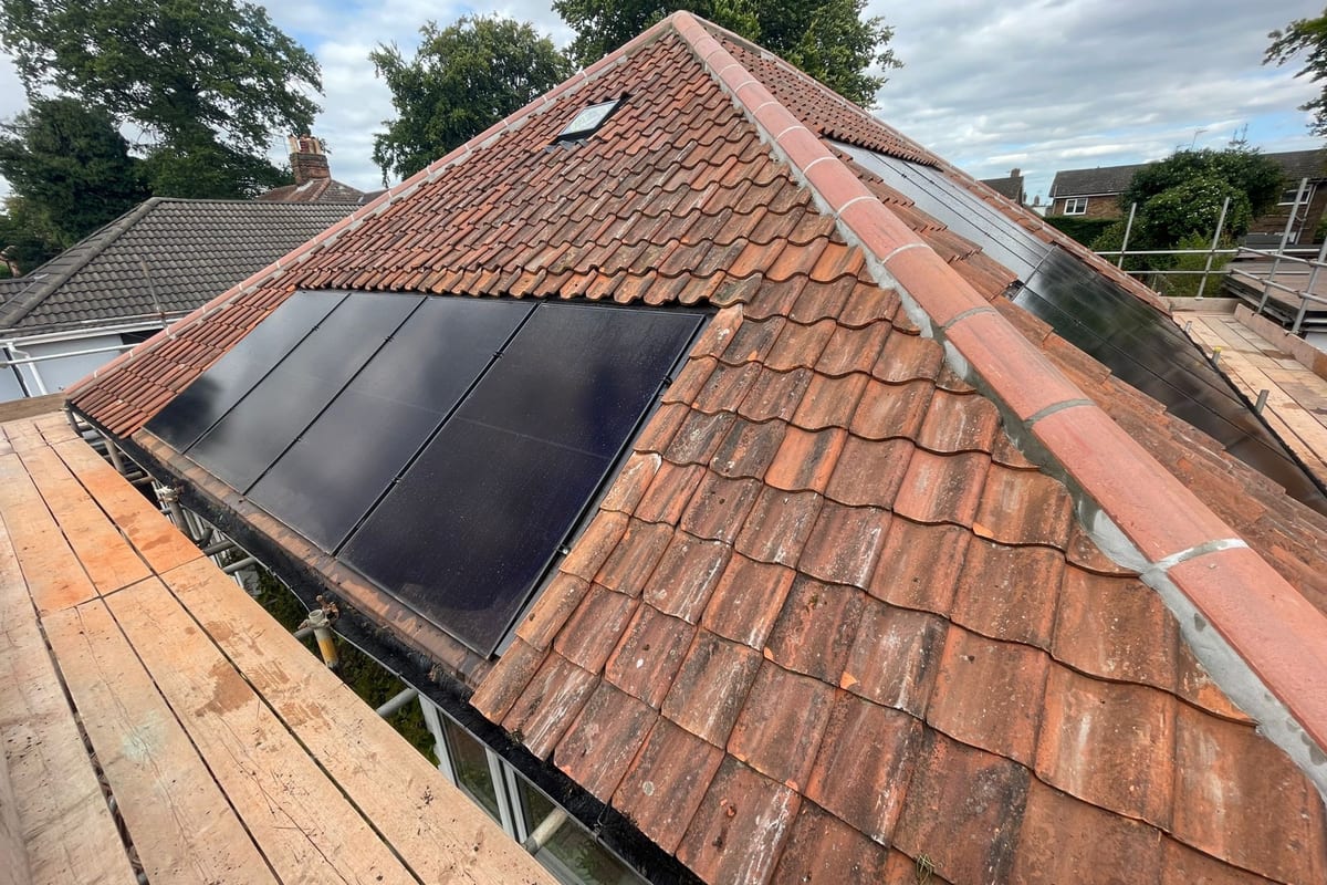 Solar panels fitted into a clay tile roof