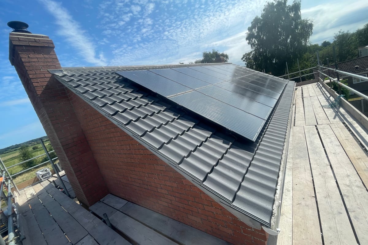 Black solar panels on a grey tiled roof