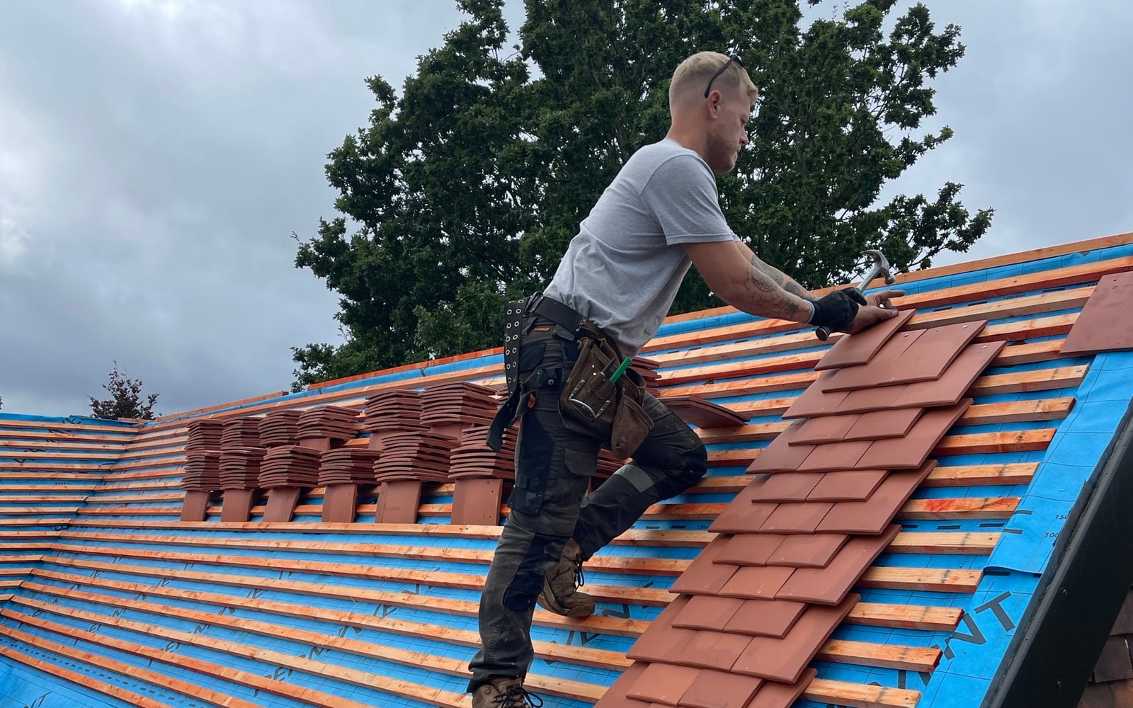 A new pitched roof in clay tiles being laid by District Roofing